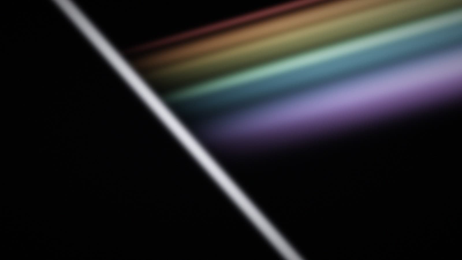 A hard white edge splitting a beam into separating bands of colour.